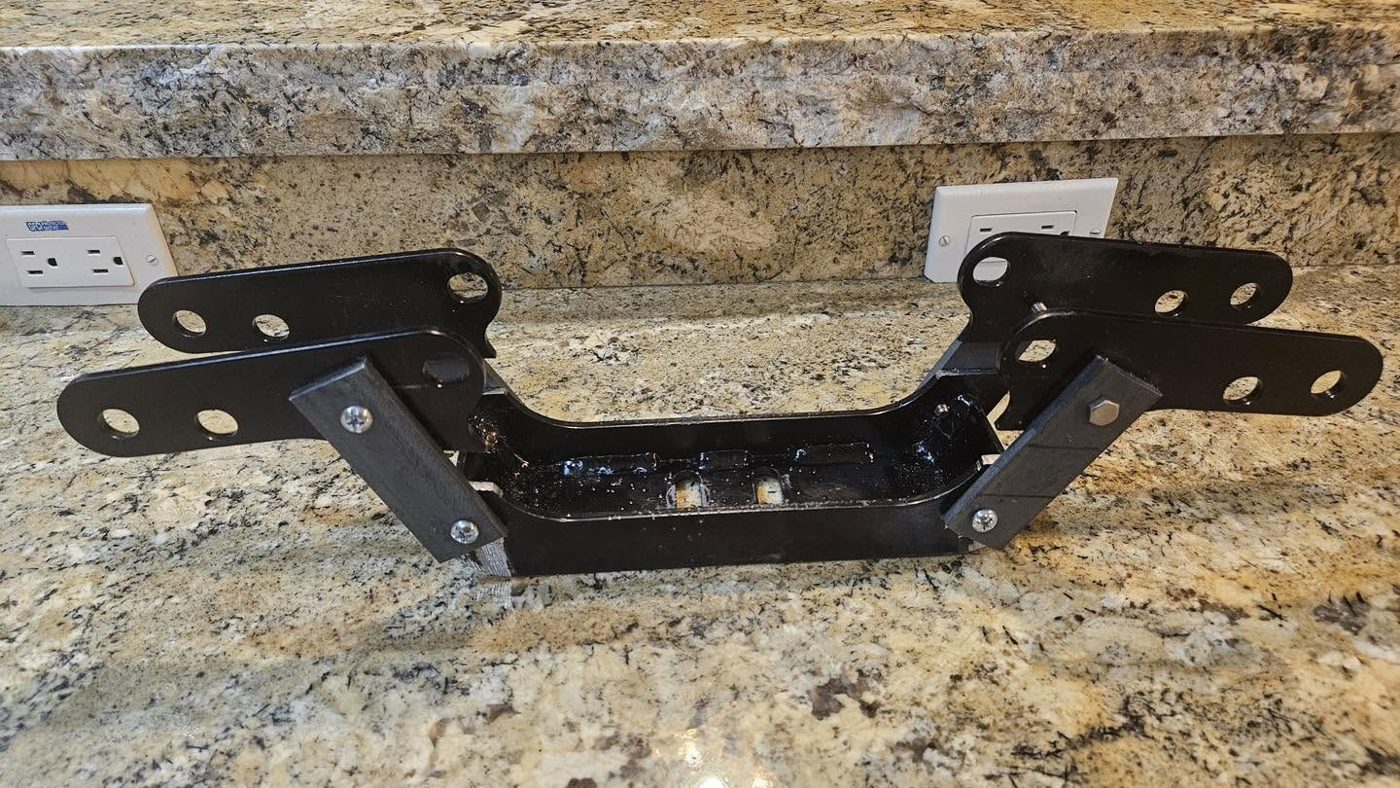 The finished pair of black steel brackets sitting on a countertop