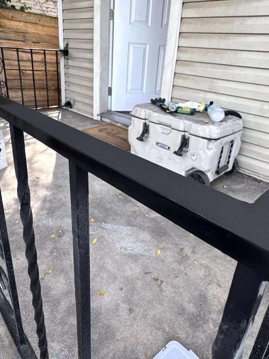 A repaired ornamental handrail, freshly painted black